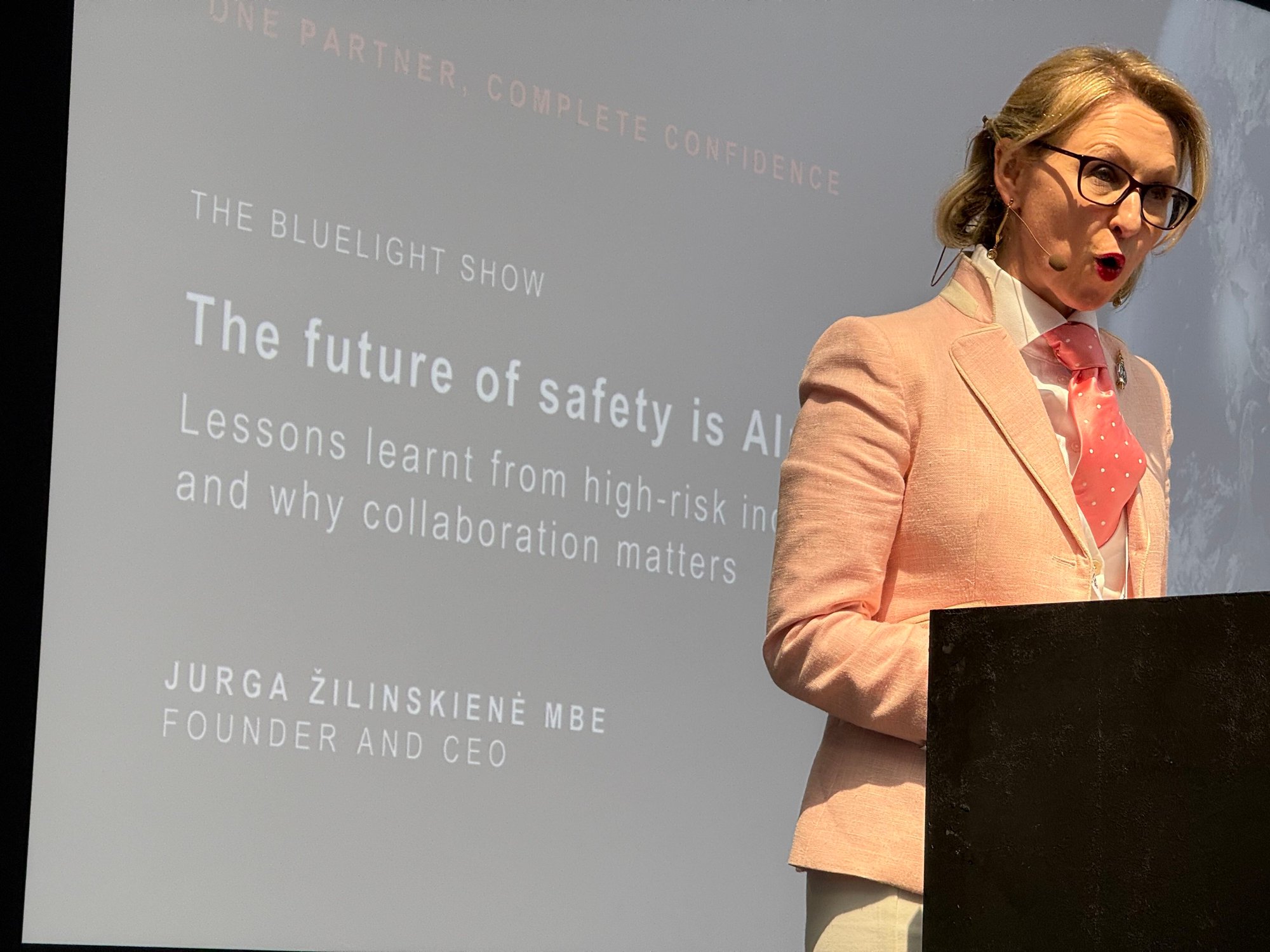 Jurga Zilinskiene MBE CEO founder of Guildhawk, GAI Translate and Evernoon Hong Kong Speaking on the keynote stage at the blue light show about how to shape the future of ethical AI in global law enforcement to protect citizens from economic crime and cyber through better multilingual collaboration and predictive data analytics