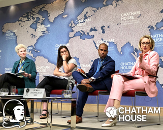 Guildhawk Evernoon AI CEO and coder Jurga Zilinskiene on stage with two women and a man. Jurga is wearing a pink suit discussing Women in Business at Chatham House in 2019.  Copyright Guildhawk
